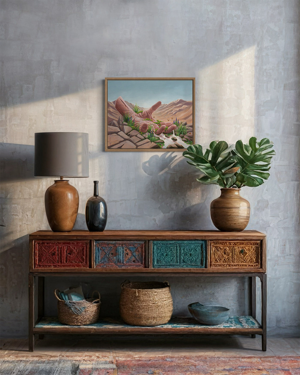 Acrylic painting of an open hand in a desert with flowing water, displayed above a cabinet with baskets and a plant