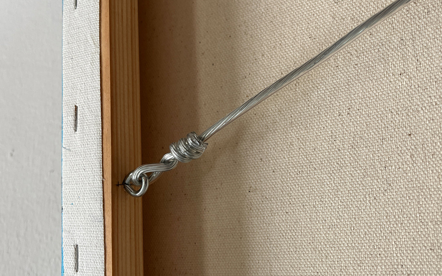 Close-up of the original artwork titled 'The Inner Child' by Glenn Verkerk, created with acrylics on canvas. The image shows the back of the canvas with a hanging system featuring silicone-coated steel wire.