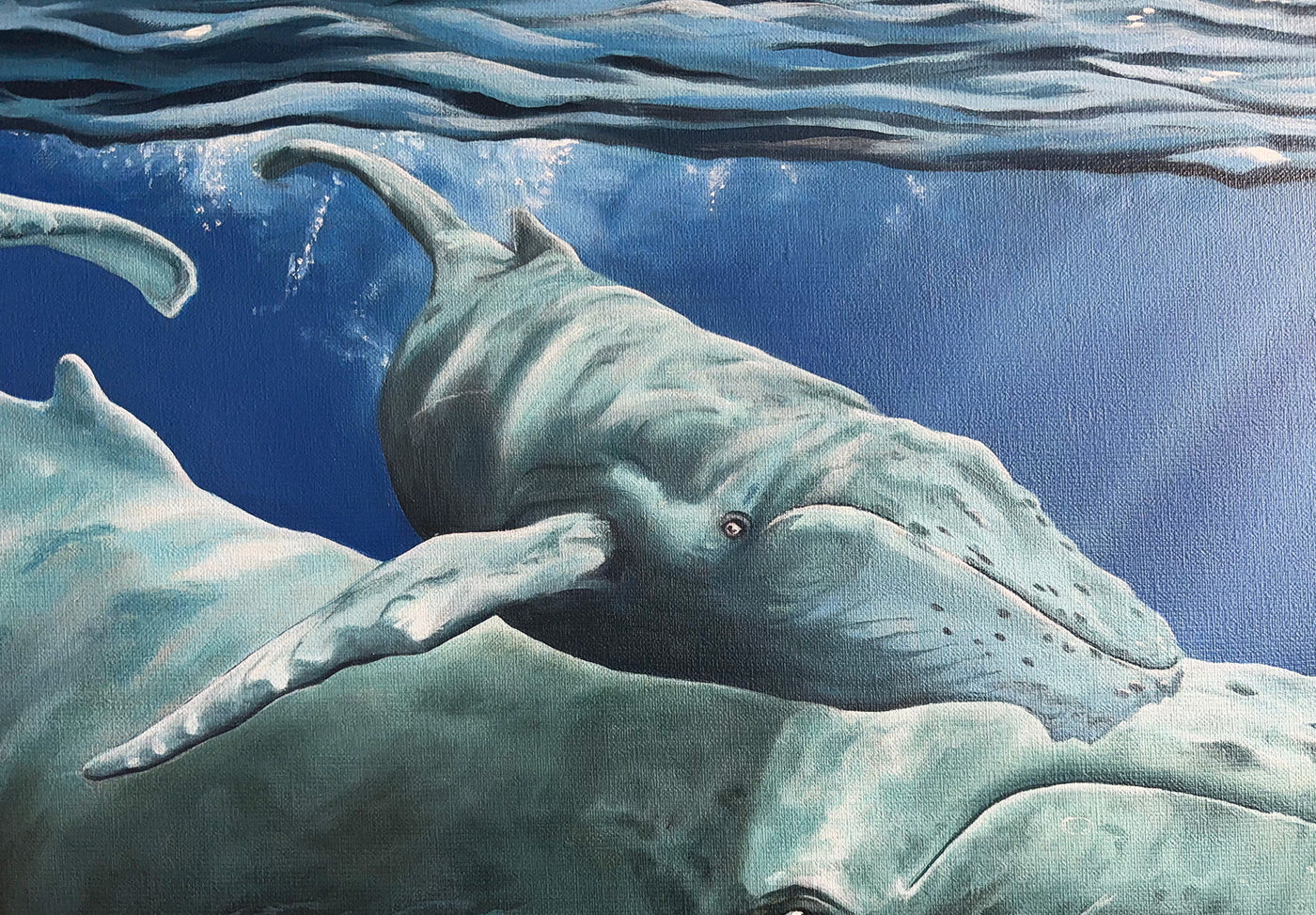 Close-up of an ocean oil painting of a whale and calf underwater with a pink inflatable flamingo drifting above