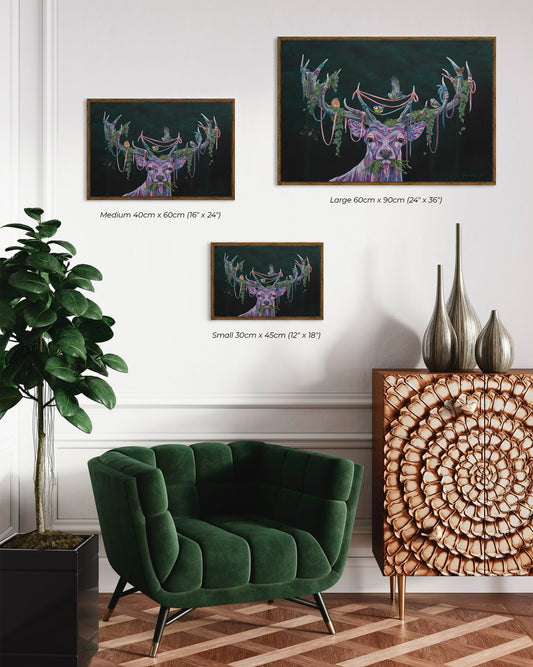 Cozy modern seating with a small wooden table and three prints of 'The Deer' by Glenn Verkerk on the wall, featuring a multicolored deer with birds and greenery in its antlers.